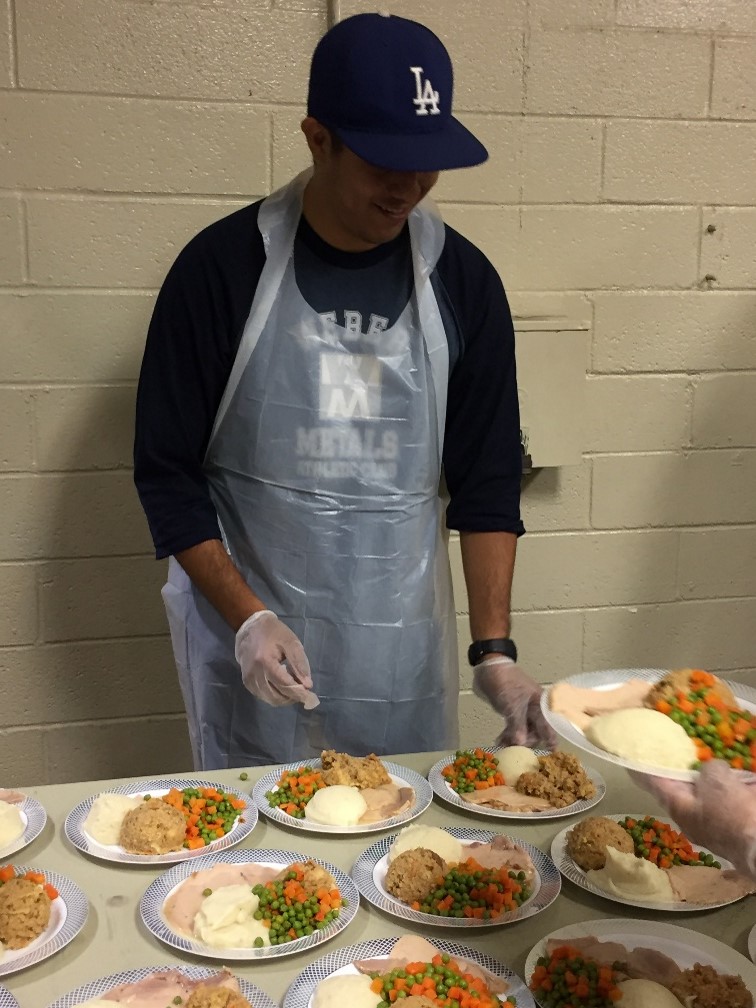 A Weber volunteer serves meals at the annual Paramount Seniors Thanksgiving lunch.